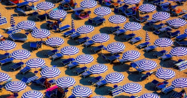 Heat Styling - Aerial View of Blue and White Open Cottages at the Beach