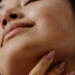 Self-Care Routine - A Woman Touching Her Neck with Her Eyes Closed