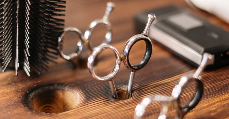 Hair Styling Tools - Silver and Black Skeleton Key on Brown Wooden Table